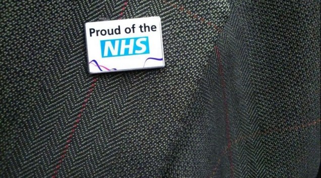 nhs-lapel-pin-national-religion-healthcare-hagiography-sps