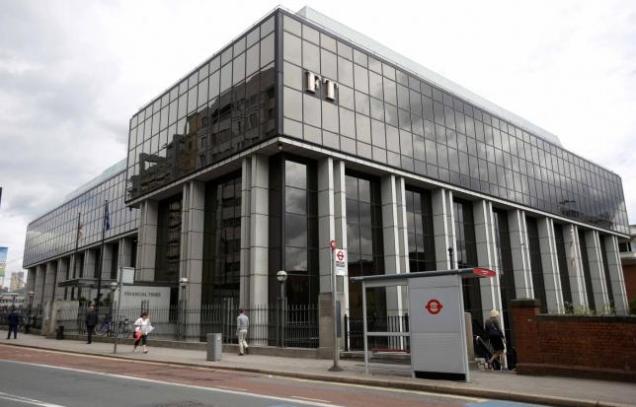 A company logo hangs on the headquarters of the Financial Times newspaper in London